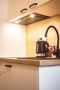 a kitchen with a tea kettle on a counter at Kawalerka w Centrum Warszawy in Warsaw