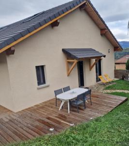 una casa con tavolo e sedie su una terrazza di Appartement rez de jardin a Saint-Martin-dʼUriage Altre 4 foto