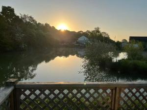 a view of a river with the sunset in the background at seven acre farm campsite in Fiskerton