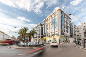 a car driving down a street in front of a building at Cartagena Centro in Cartagena