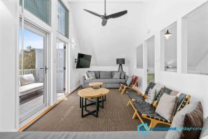 a living room with a couch and a table at Ocean Dunes - Absolute Beachfront with Fireplace in Culburra Beach