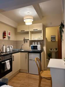 a kitchen with a sink and a counter top at Cozy studio in London