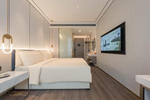 Giường trong phòng chung tại Atour X hotel Shanghai Wujiaochang INNO Chuangzhi