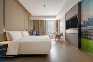 a large white bed in a hotel room at Atour Hotel Shenzhen Nanshan Shekou in Shenzhen