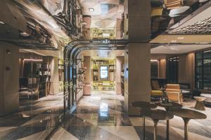 a lobby with tables and chairs in a building at Atour Hotel Shanghai The Bund East Nanjing Road-Self-service free laundry in Shanghai