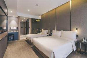 a hotel room with two beds and a kitchen at Atour Hotel Shanghai The Bund East Nanjing Road-Self-service free laundry in Shanghai +29 photos