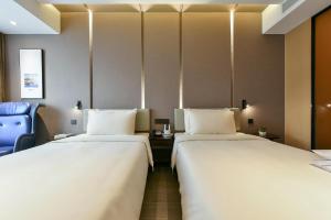 Ένα ή περισσότερα κρεβάτια σε δωμάτιο στο Atour Hotel Beijing Wangjing Science and Technology Park