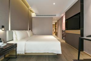 Ένα ή περισσότερα κρεβάτια σε δωμάτιο στο Atour Hotel Beijing Wangjing Science and Technology Park