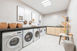 a laundry room with washing machines and a counter at Atour Hotel Dalian Zhongshan Square in Dalian