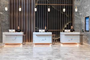three women sitting at tables with their laptops at Atour Hotel Kunming Nanyue City in Kunming