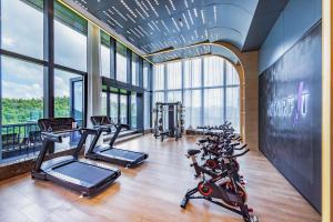 a gym with a bunch of bikes in a room with windows at Atour S Hotel Zhuhai Gongbei Port NetEase Selected in Zhuhai