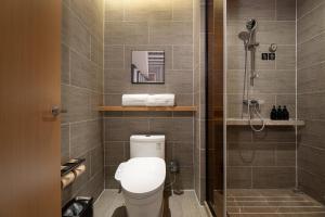a bathroom with a shower and a toilet in it at Atour Hotel Dalian Xinghai Square in Dalian +63 photos