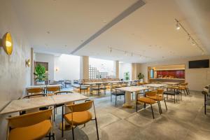 a restaurant with tables and chairs and a bar at Atour X Hotel Shanghai Central Bailian Tongchuan Road Station in Shanghai