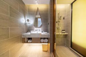 a bathroom with a sink and a shower at Atour Hotel Guiyang Guanshan Lake Park in Guiyang