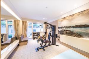 a room with a gym with a bench and a chair at Atour Hotel Yantai South Station Yingchun Street in Yantai