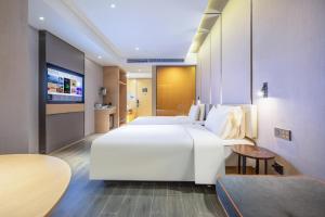 Ένα ή περισσότερα κρεβάτια σε δωμάτιο στο Atour Hotel Hefei North Square South Station