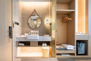 a bathroom with a sink and a mirror at Atour Light Hotel Shenzhen Nanshan Shenzhen Bay in Shenzhen