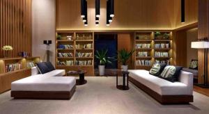 a living room with two couches and book shelves at Atour Hotel Chengdu Consulate South Renmin Road in Chengdu