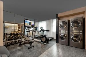 a fitness room with a gym with washing machines at Atour Hotel Anji Longshan in Anji