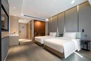Postel nebo postele na pokoji v ubytování Atour Hotel Shaoxing Heqiao