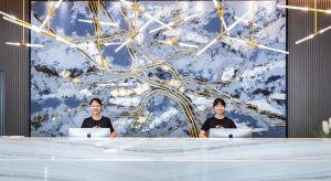 two men sitting at a table with their laptops at Atour Hotel Guangzhou Huadu Square in Huadu