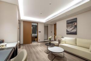 a living room with a couch and a table at Atour Hotel Quanzhou Jinjiang Sunshine Plaza in Jinjiang