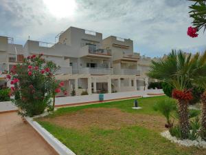 a large apartment building with a garden in front of it at Spacious and luxurious apartment in Mojácar