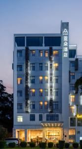 a building with a lit up sign on it at Atour Hotel Xiamen Haicang Gulangyu Pier Seaview in Xiamen