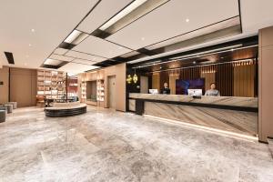 a lobby of a hotel with a reception desk at Atour Hotel Beijing East Gate of Heaven Temple in Beijing