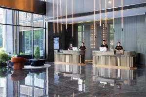 a group of people working in a lobby at Atour S Hotel Ningbo Zhoushan East Road in Ningbo