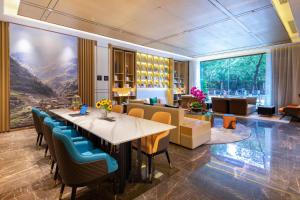 a dining room with a long table and chairs at Atour Hotel Kunming Cuihu in Kunming