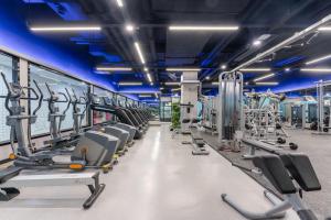 a gym with rows of treadmills and machines at Atour Hotel Chongqing Tiandi NetEase Cloud Music in Chongqing