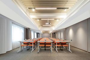 a conference room with tables and orange chairs at Atour Hotel Nanchang Bayi Square Provincial Television Station in Nanchang