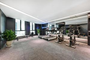 a gym with treadmills and exercise equipment in a building at Atour Hotel Tianjin Eye in Tianjin