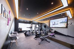 a gym with several treadmills and a flat screen tv at Atour Hotel Wuhan Tiandi Hankou Jiangtan in Wuhan
