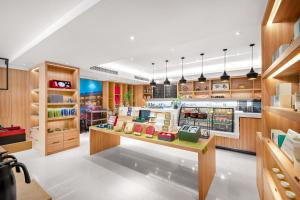 a shop with wooden cabinets and a counter in a store at Atour Hotel Chengdu Taikoo Li Riverside in Chengdu