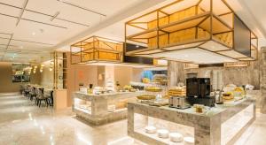 a restaurant with a counter with food on it at Atour Hotel Wuxi Sanyang Plaza in Wuxi +33 photos