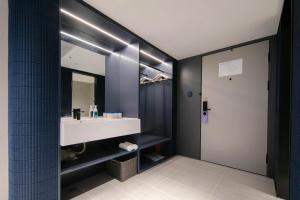 a bathroom with a sink and a mirror at Atour Light Hotel Wuhan Jiangtan Jianghan Road Pedestrian Street in Wuhan