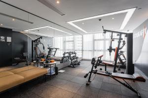 a gym with several tread machines in a room at Atour Hotel Tianjin Binhai High Speed Railway Station in Binhai