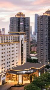 a hotel with a night view of a city at Atour S Hotel Ningbo Zhoushan East Road in Ningbo