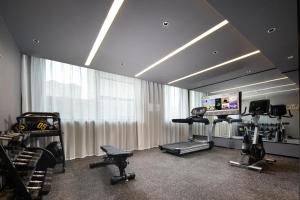 a gym with several treadms and machines in a room at Atour Hotel Nantong North Street Vientiane City in Nantong