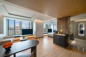 a living room with a couch and a table at A T HOUSE Shanghai Xujiahui in Shanghai