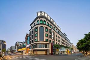 a large building on a city street with a street at Atour Hotel Quanzhou Jinjiang Sunshine Plaza in Jinjiang