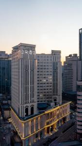 a large building with a clock on it in a city at Atour Hotel Shenyang Zhongshan Plaza in Shenyang