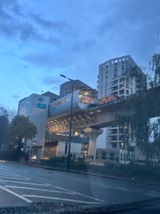 a train on a bridge over a city street at Specious apartment In Canning Town ( London ) in London