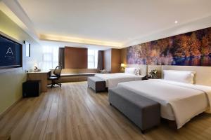 a hotel room with two beds and a desk at Atour Hotel Chengdu Consulate South Renmin Road in Chengdu