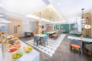 a restaurant with tables and chairs and fruit on display at Atour Hotel Shenzhen Nanshan Xili Station in Shenzhen