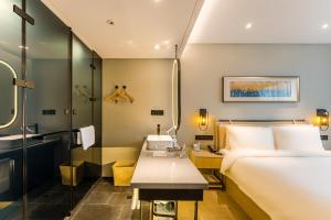 a hotel room with a bed and a shower at Atour X Hotel Shanghai Pudong Zhangjiang Park in Shanghai