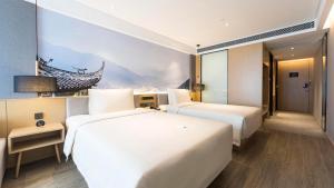 Postel nebo postele na pokoji v ubytování Atour Hotel Chengdu Jiuyanqiao NetEase Selected