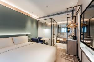 Atour S Hotel Beijing Shangdi Qinghe High Speed Railway Station في بكين: غرفه فندقيه بسرير وحمام